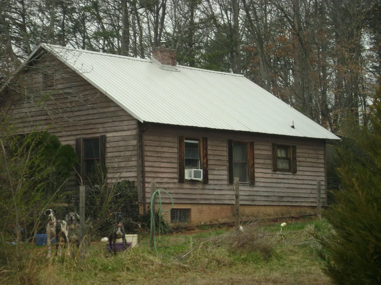 White metal roof on an old wood sided farmhouse, from a Metal Roof Installation job in Pike